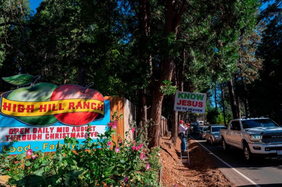 A man who goes by “Gospel Gary” takes advantage of the slow-moving traffic on Carson Road in front of High Hill Ranch, to preach Saturday at Apple Hill.