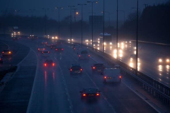 Cars and traffic on a wet raining evening on uk motorway.Driving in dangerous winter conditions.