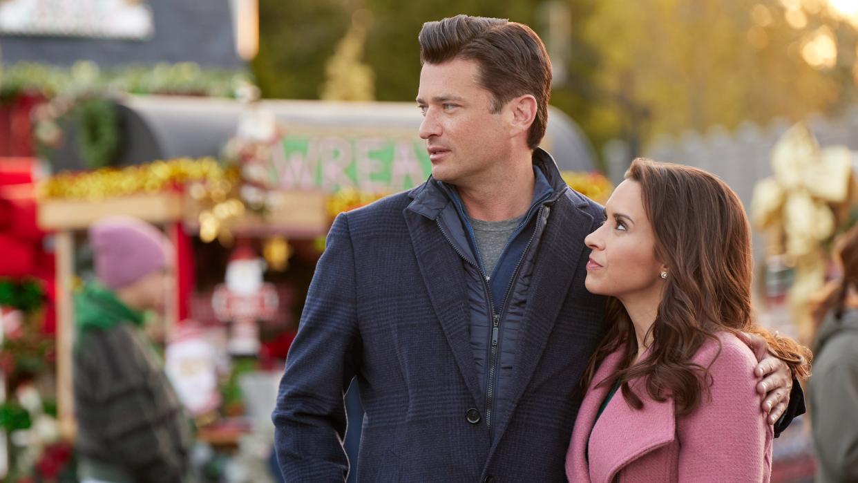  Lacey Chabert and Wes Brown look on in Haul Out the Holly: Lit Up. 