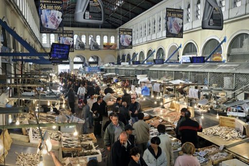 People shop at a fish and meat market in central Athens, on November 1. Greek Prime Minister George Papandreou triggered turmoil across the eurozone, stock market mayhem and a domestic political crisis with a shock move to put a hard-won debt deal to a referendum