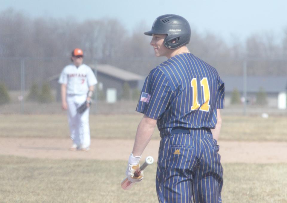 Louden Stradling checks the signs with his coach during a baseball matchup between Gaylord and Rudyard on Tuesday, April 11.