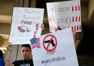 <p>Protesters hold signs at a rally for gun control at the Broward County Federal Courthouse in Fort Lauderdale, Fla., Feb. 17, 2018. (Photo: Rhona Wise/AFP/Getty Images) </p>