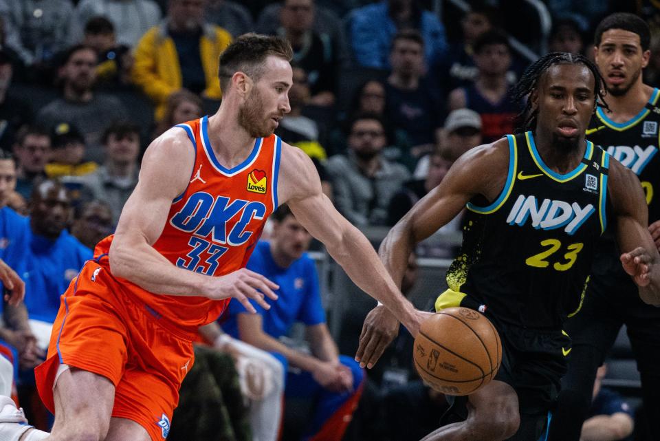 Apr 5, 2024; Indianapolis, Indiana, USA; Oklahoma City Thunder forward Gordon Hayward (33) dribbles the ball while Indiana Pacers forward Aaron Nesmith (23) defends in the first half at Gainbridge Fieldhouse.