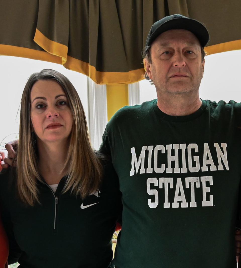Professor Tina Timm and Professor Adrian Blow stand together in their home in Okemos, Mich.