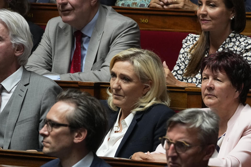 Far-right leader and newly re-elected parliament member Marine Le Pen, center, sits at the National Assembly, Tuesday, June 28, 2022 in Paris. France's National Assembly convenes for the first time since President Emmanuel Macron lost his parliamentary majority. (AP Photo/Michel Euler)
