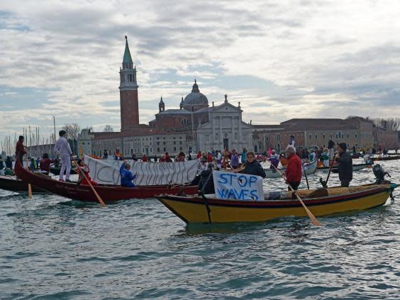 Rowing and sailing boats sail along the St Mark’s basin as Venetians protest against the damage caused by waves created by large motorboats (AP)