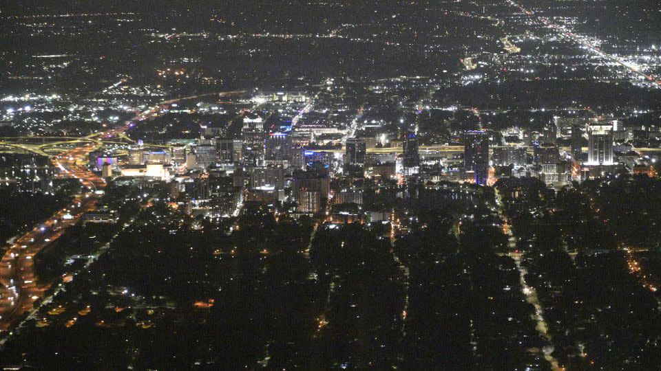 An aerial perspective of the downtown nighttime skyline is viewed on July 20, 2023, in Orlando, Florida. - Phelan M. Ebenhack/AP