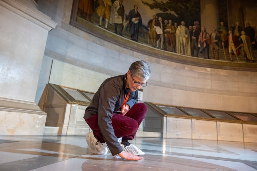 Amy Lubick, a supervisory conservator at the National Archives, looks over the stained floors at National Archives in Washington on Thursday, Feb. 15, 2024. The National Archives building and galleries were evacuated on Feb. 14 after two protesters dumped powder on the protective casing around the U.S. Constitution. (AP Photo/Amanda Andrade-Rhoades)