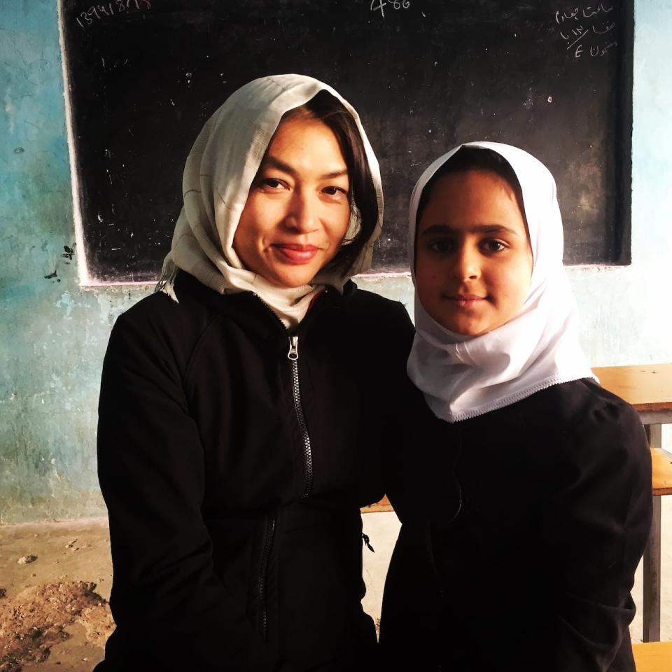 Reporter Mellissa Fung with a student at a girls' school in Herat, 2015. Photo credit: Sat Nandlall