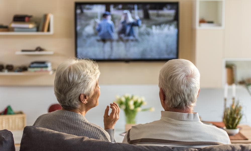 Senior couple watching a television show