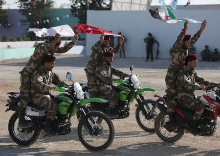 Fighters of National Army, backed by Turkey, ride on motorbikes during a graduation ceremony in the city of al-Bab, Syria August 5, 2018. REUTERS/Khalil Ashawi