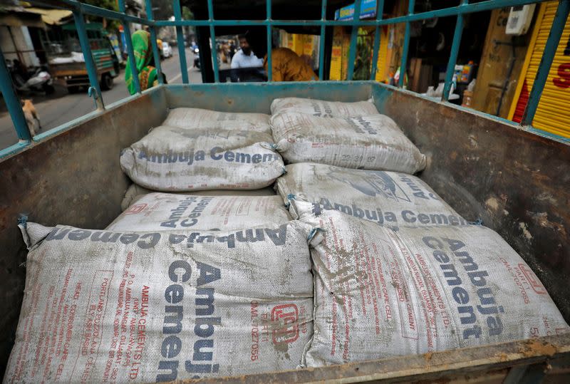 A view shows Ambuja Cement bags, to be carried to a construction site, in a load carrier in Ahmedabad