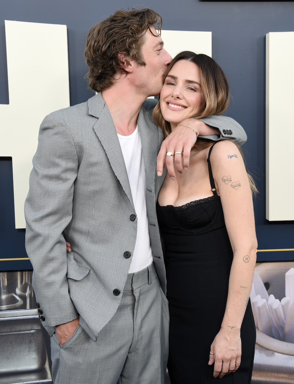 Closeup of Jeremy Allen White kissing Addison Timlin on the cheek