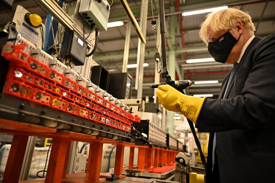 British Prime Minister Boris Johnson visits the Envision battery manufacturing facility at the Nissan production plant in Sunderland, north east England on July 1, 2021. - Japanese auto giant Nissan today announced plans to build the UK's first car-battery 