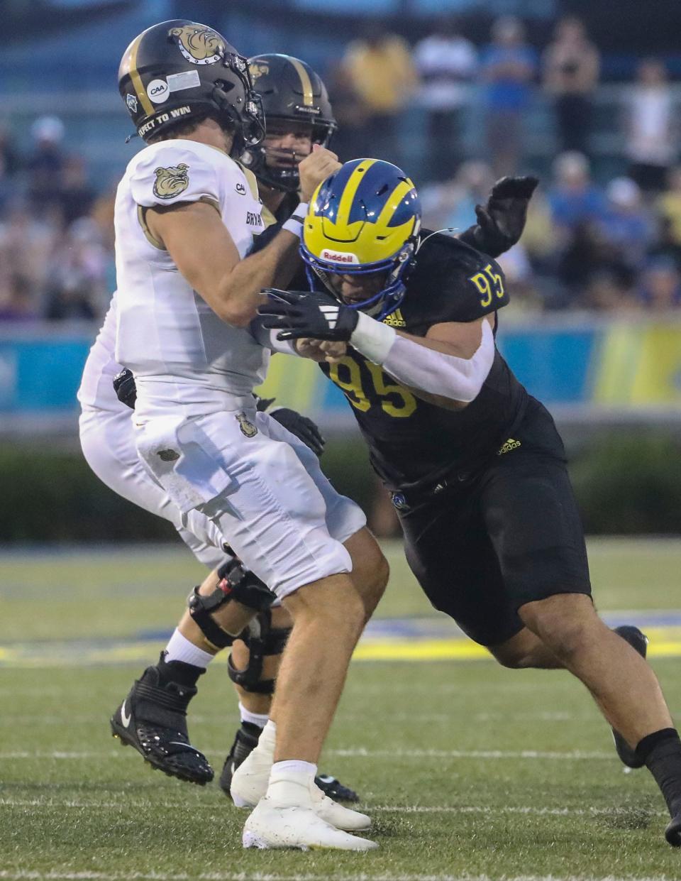 Delaware's defensive lineman Melkart Abou-Jaoude pressures Bryant quarterback Jarrett Guest in the first quarter at Delaware Stadium, Thursday, August 29, 2024.