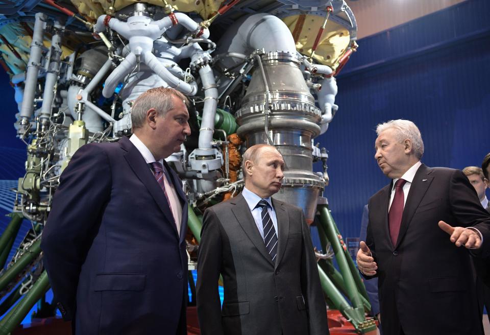 Russian President Vladimir Putin (C) and state space corporation Roscosmos head Dmitry Rogozin (L) listen to Director of Russian rocket engine manufacturer NPO Energomash Igor Arbuzov in Khimki, outside Moscow April 12, 2019.  / Credit: ALEXEY NIKOLSKY/AFP/Getty