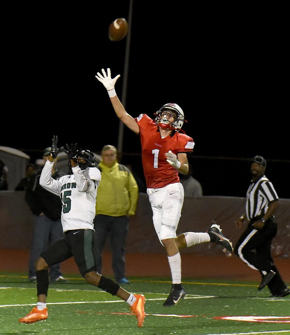 Aiden Brodie of Monroe defends Ann Arbor Huron receiver Davis Hugan during a 40-0 Monroe loss Friday night.