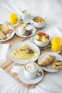 <p>Usually, one person makes the other breakfast in bed, but there's no reason both of you can't curl up under the covers with coffee, pastries, and eggs.</p><p><strong>Get <a href="https://www.countryliving.com/breakfast-recipes/" rel="nofollow noopener" target="_blank" data-ylk="slk:easy breakfast recipe;elm:context_link;itc:0;sec:content-canvas" class="link ">easy breakfast recipe</a> ideas. </strong></p><p><a class="link " href="https://www.amazon.com/Bamboo-Foldable-Breakfast-Working-Pipishell/dp/B088K4X3YJ/ref=sr_1_2?keywords=breakfast+tray&qid=1642697495&sr=8-2&tag=syn-yahoo-20&ascsubtag=%5Bartid%7C10050.g.30445302%5Bsrc%7Cyahoo-us" rel="nofollow noopener" target="_blank" data-ylk="slk:SHOP BREAKFAST TRAYS;elm:context_link;itc:0;sec:content-canvas">SHOP BREAKFAST TRAYS</a></p>