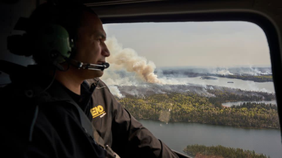 Manitoba Premier Wab Kinew surveys wildfires burning in northern Manitoba on May 14, 2024. - David Lipnowski/AP