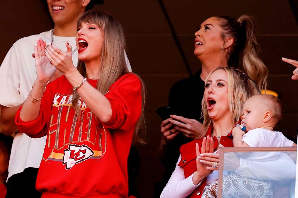 <p>David Eulitt/Getty </p> Taylor Swift and Brittany Mahomes react during a game between the Los Angeles Chargers and Kansas City Chiefs at GEHA Field at Arrowhead Stadium on October 22, 2023 in Kansas City, Missouri.