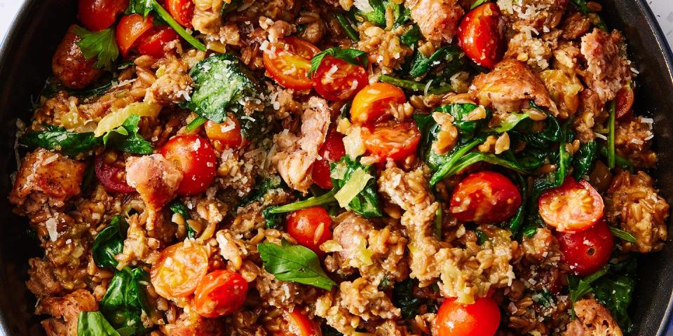 one pot farro with chicken sausage and tomatoes topped with fresh herbs