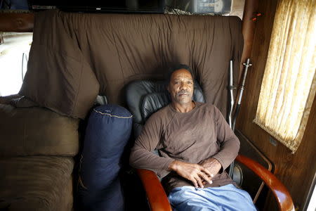 Charles Heard, 58, poses for a portrait in a recreational vehicle (RV) in which he has lived for a year on the streets of Los Angeles, California, United States, November 12, 2015. REUTERS/Lucy Nicholson