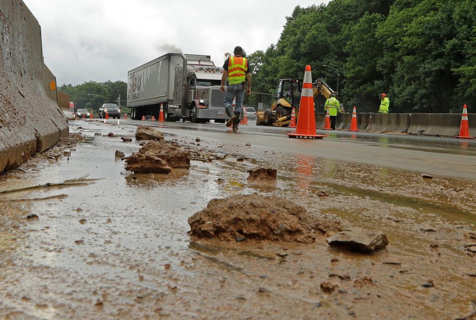 Workers block off lanes of Interstate 40 near Old Fort, N.C., May 30, 2018, after heavy rains from the fringes of Subtropical Storm Alberto caused a mudslide.