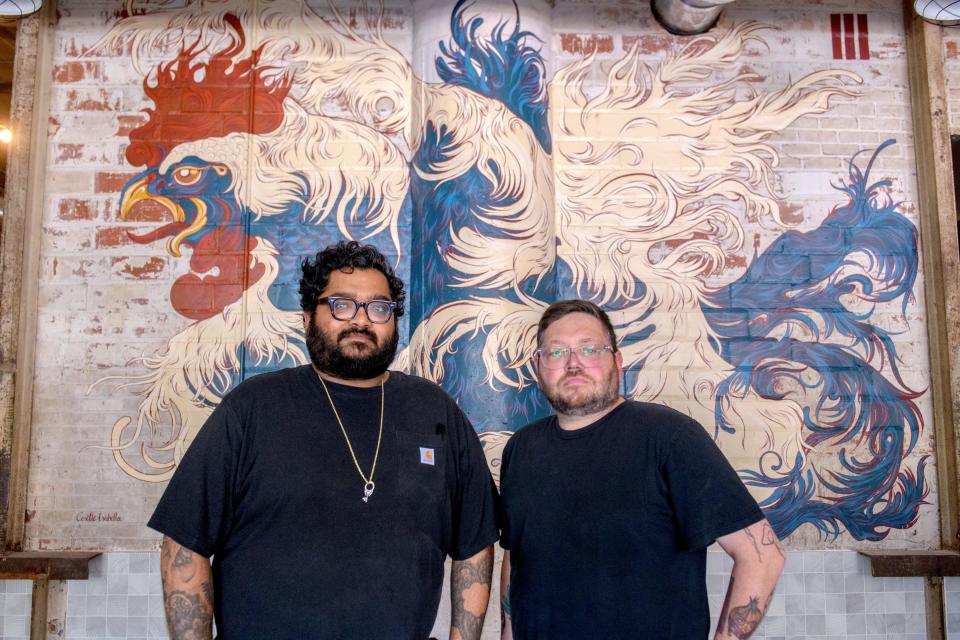 Owner Aaron Harris, left, and general manager Ryan Smith stand next to a large mural of a rooster by Peoria artist Cosette Isabell in their new Pop-Up Chicken Shop restaurant in the 800 block of SW Adams in Peoria's Warehouse District. The new casual eatery is an expansion of Harris original restaurant in Bloomington featuring "Illinois Hot Chicken" among other entrees.