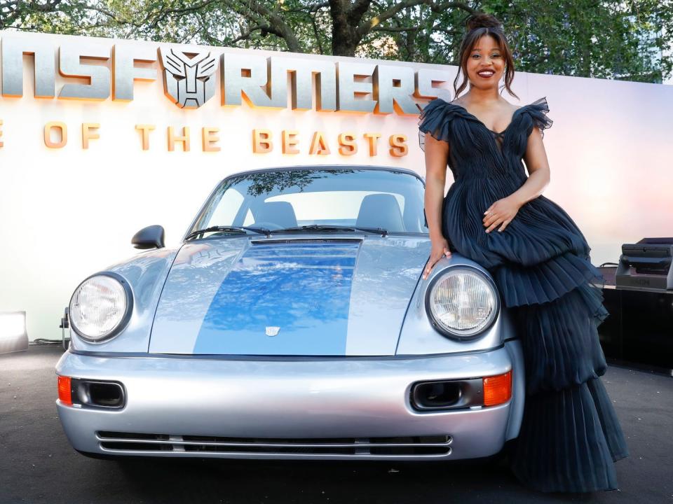 Dominique Fishback sits on a replica of Mirage in porsche mode at the European Premiere of Paramount Pictures' "Transformers: Rise of the Beasts."