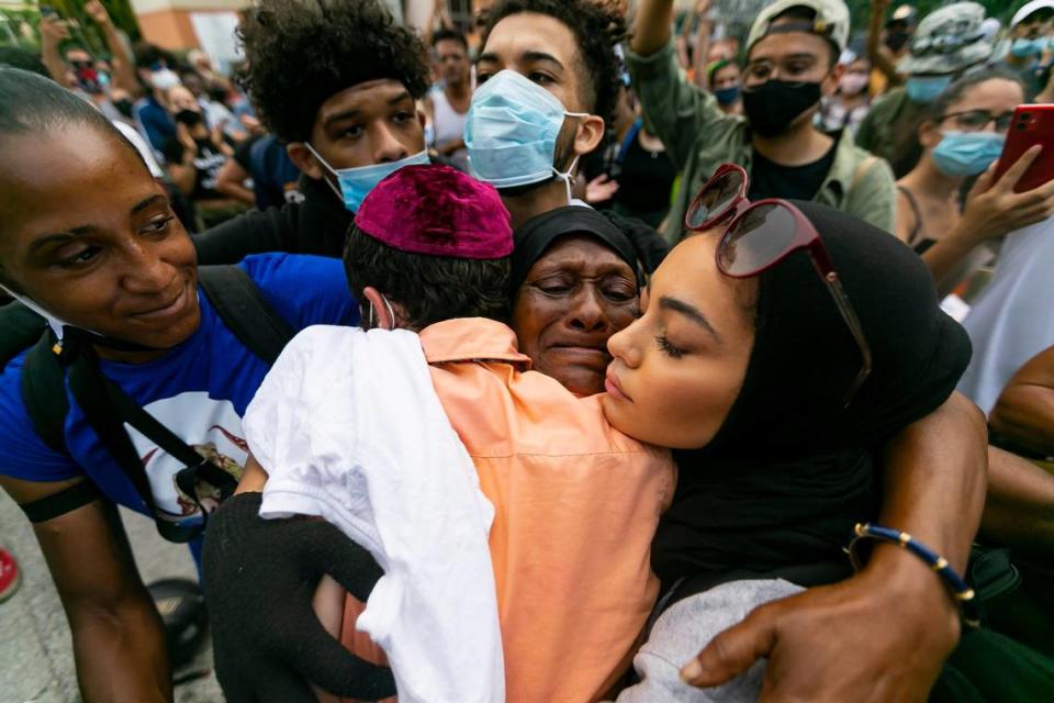 Elaine Williams, 62, center, receives hugs from activists after she spoke during a a Justice for George Floyd protest near the Miami-Dade State AttorneyÕs Office in Allapattah on Monday, June 1, 2020.