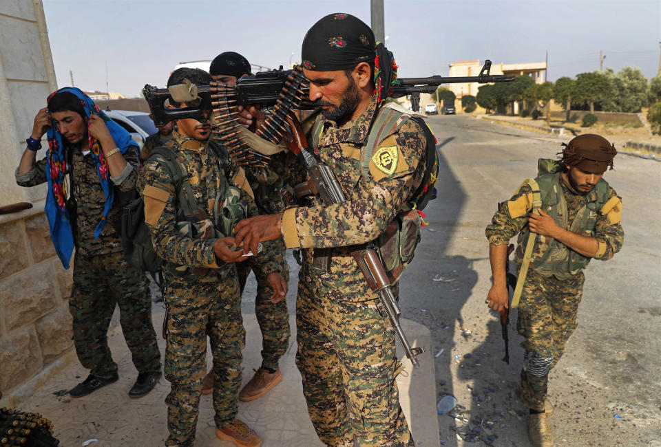 FILE - U.S.-backed Syrian Democratic Forces (SDF) fighters, prepare for battle against Islamic state group militants, in Raqqa, northeast Syria, on June 22, 2017. Syria’s civil war has entered its 14th year on Friday March 15, 2024, a somber anniversary in a long-frozen conflict. The country is effectively carved up into areas controlled by the Damascus government, various opposition groups and Kurdish forces. (AP Photo/Hussein Malla, File)