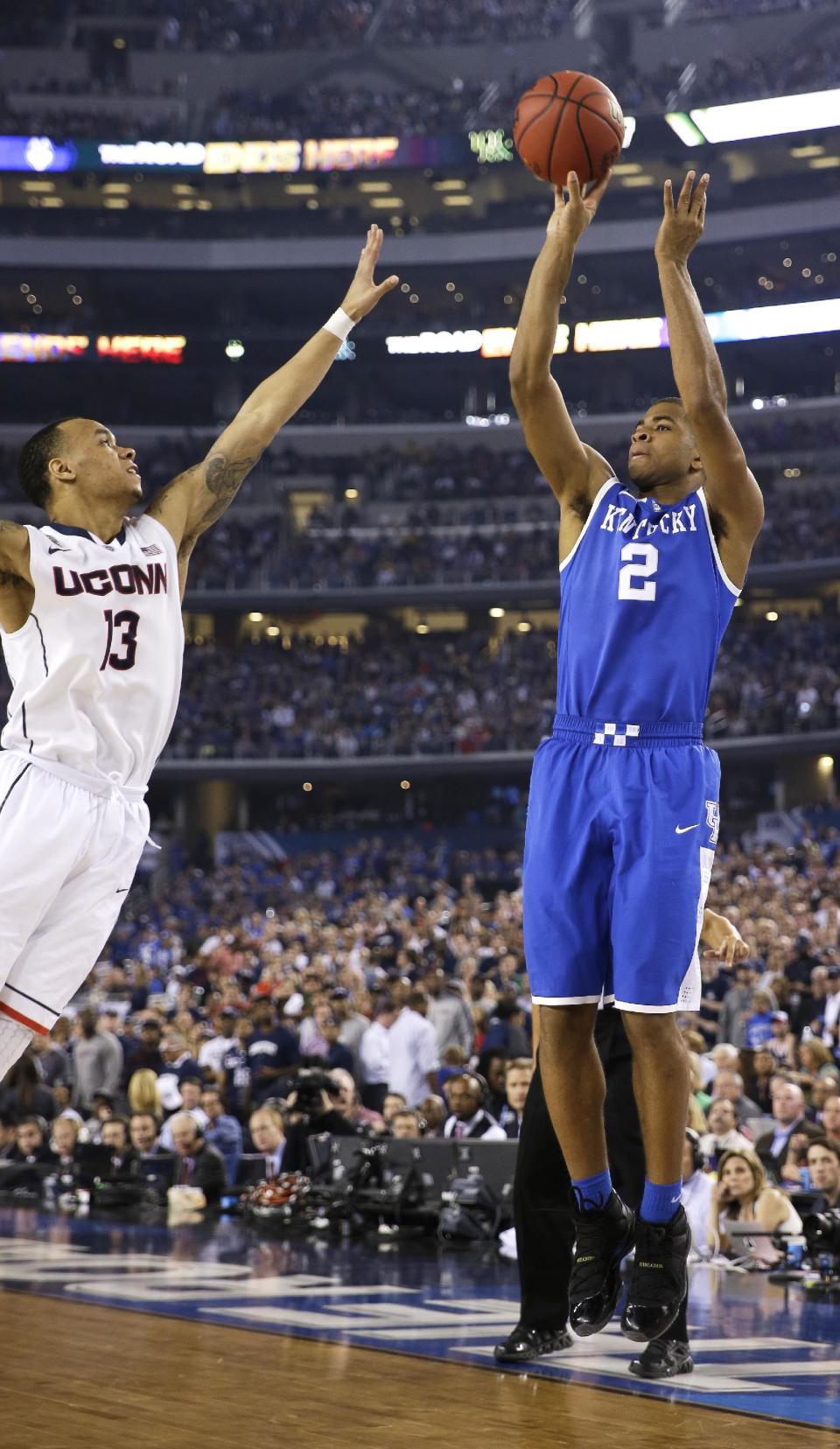 Kentucky guard Aaron Harrison (2) shoots over Connecticut guard Shabazz Napier, left, during the second half of the NCAA Final Four tournament college basketball championship game Monday, April 7, 2014, in Arlington, Texas. (AP Photo/David J. Phillip)