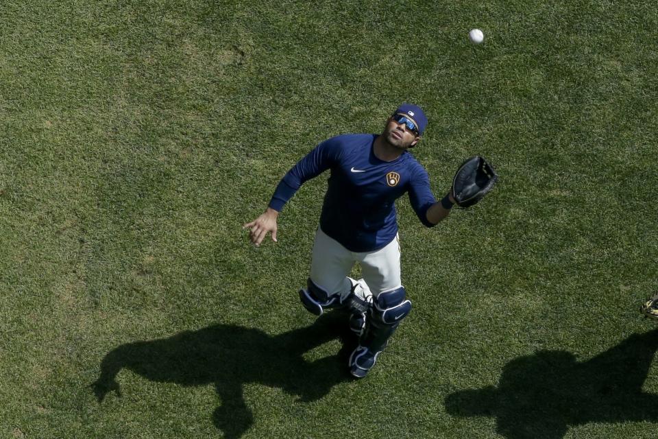 Milwaukee Brewers' Manny Pina catches a ball during a practice session Monday, July 13, 2020, at Miller Park in Milwaukee. (AP Photo/Morry Gash)