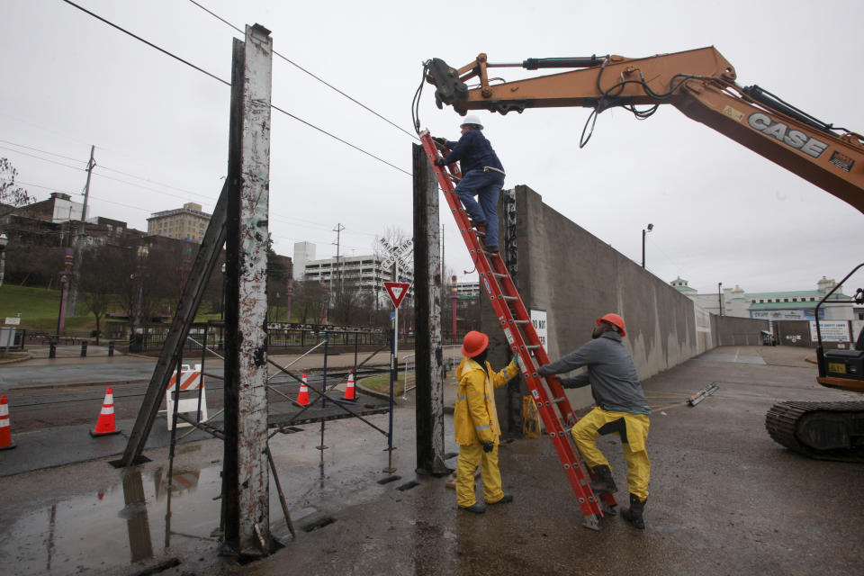 Workers with the City of Vicksburg start construction on one of the three flood wall gates on Levee Street in Vicksburg Miss., on Thursday Feb. 21, 2019. According to the National Weather Service the Mississippi River is currently at 44.69 feet and is expected to reach 48.9 feet. (Courtland Wells/The Vicksburg Post, via AP)