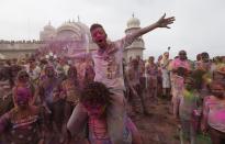 Revelers covered in colored corn starch celebrate during the 2014 Festival of Colors, Holi Celebration at the Krishna Temple Saturday, March 29, 2014, in Spanish Fork, Utah. Nearly 70,000 people are expected to gather starting Saturday at a Sri Sri Radha Krishna Temple in Spanish Fork for the annual two-day festival of colors. Revelers gyrate to music and partake in yoga during the all-day festival, throwing colored corn starch in the air once every hour. The Salt Lake Tribune reports that the large majority of participants are not Hindus, but Mormons. Thousands of students from nearby Brigham Young University come to take part in a festival that is drug and alcohol free. The event stems from a Hindu tradition celebrating the end of winter and the triumph of good over evil. (AP Photo/Rick Bowmer)