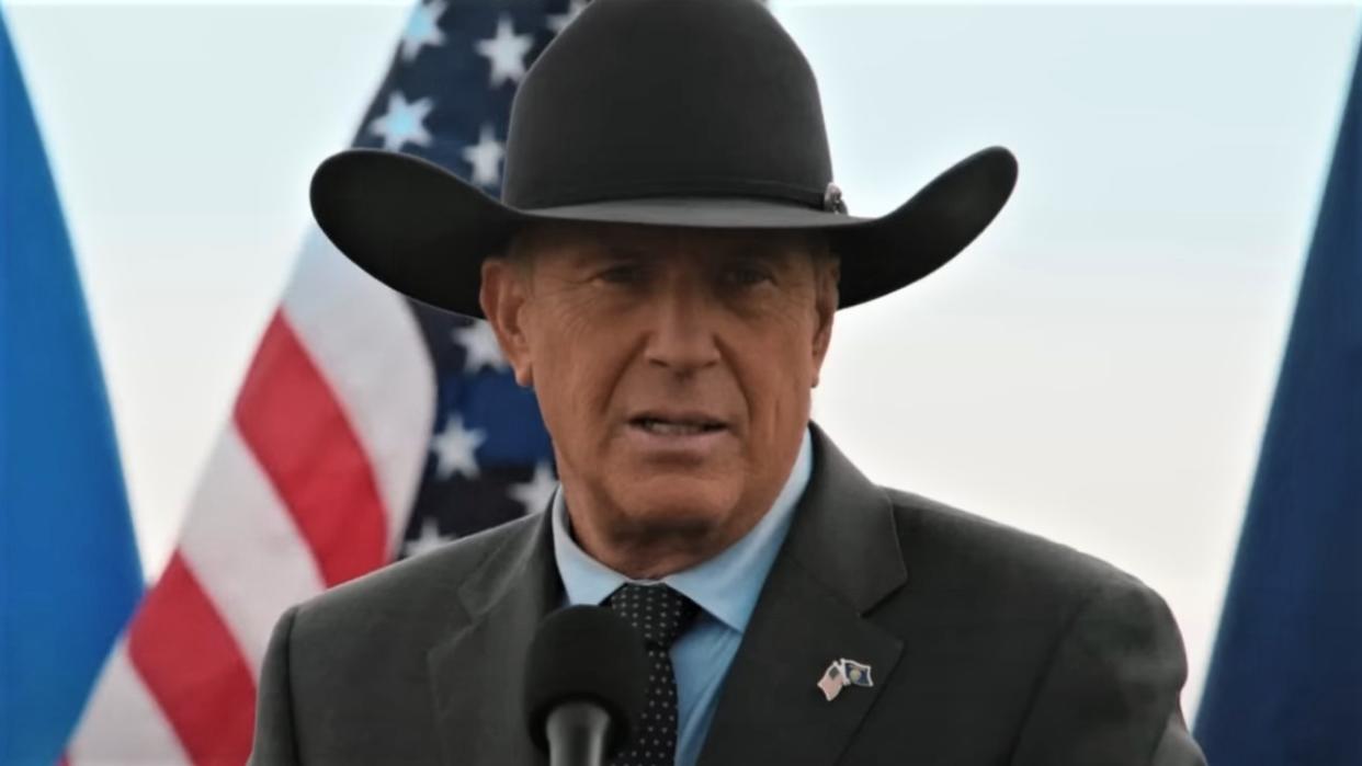  John Dutton and American flag in Yellowstone 