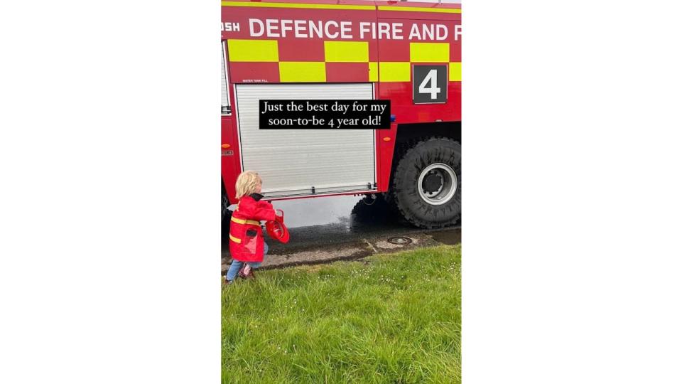 Wilf Johnson walking alongside a fire engine