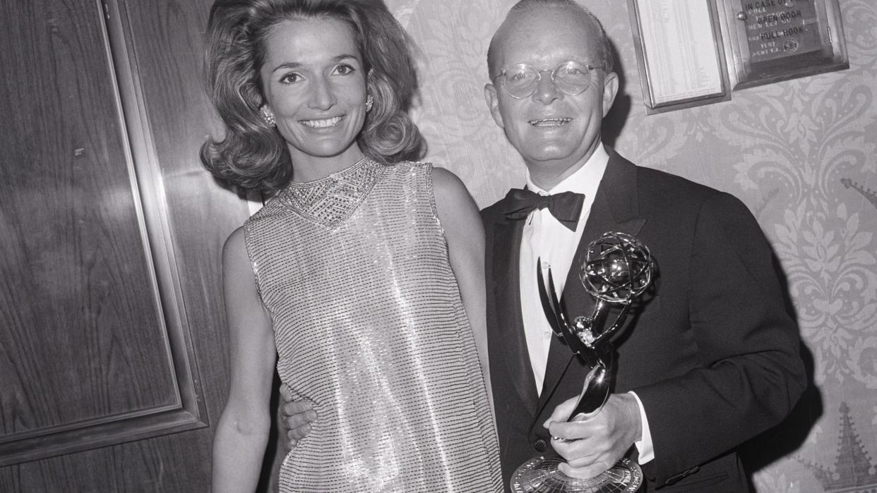 lee radziwill standing next to truman capote who is holding an emmy trophy and the both of them smiling