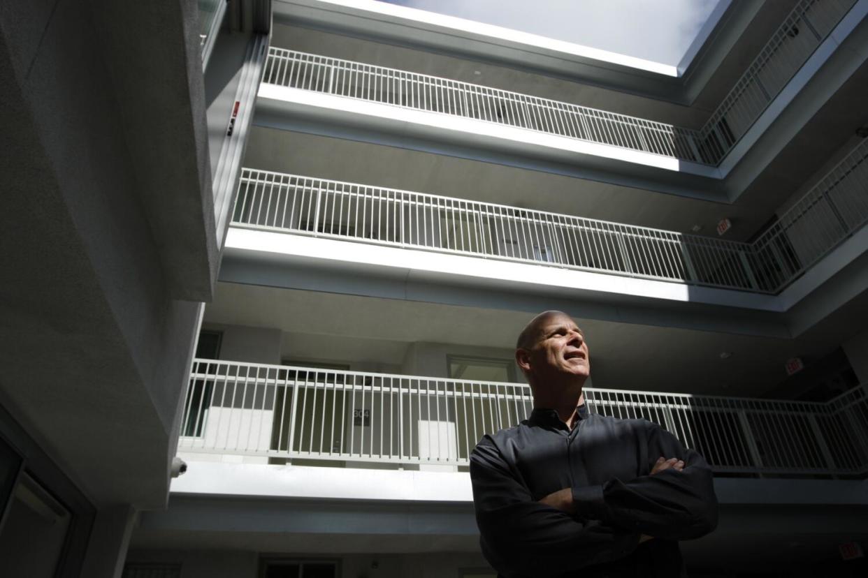 Tod Lipka stands in a courtyard.