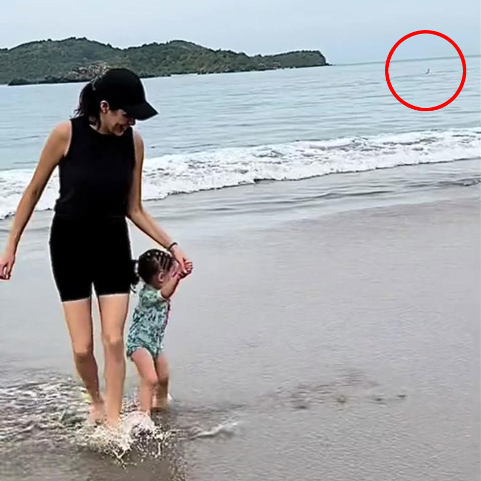 Video grab (Image cropped and swimmer circled) of Marlene Luviano with her daughter as the tourist is supposedly attacked by a shark.