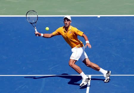 Aug 22, 2015; Cincinnati, OH, USA; Novak Djokovic (SRB) returns a shot against Alexandr Dolgopolov (not pictured) in the semifinals during the Western and Southern Open tennis tournament at the Linder Family Tennis Center. Mandatory Credit: Aaron Doster-USA TODAY Sports