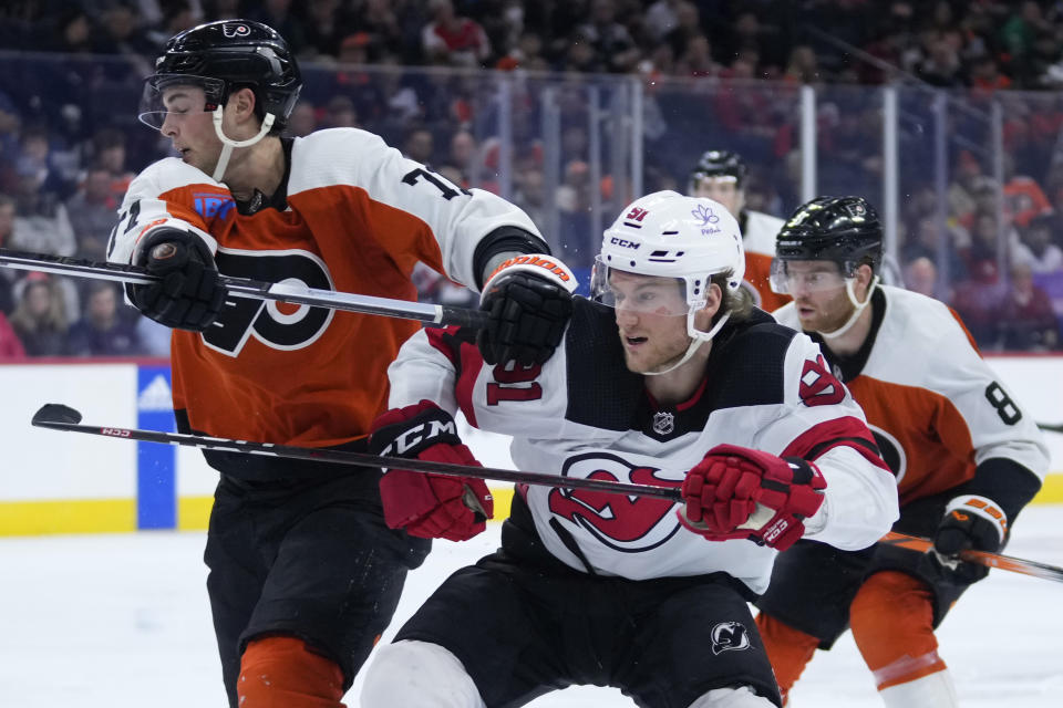 New Jersey Devils' Dawson Mercer (91) collides with Philadelphia Flyers' Tyson Foerster (71) during the third period of an NHL hockey game, Thursday, Nov. 30, 2023, in Philadelphia. (AP Photo/Matt Slocum)