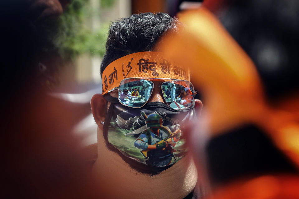 An activist of Rashtriya Bajrang Dal participates in a ceremony to mark the groundbreaking ceremony of a temple dedicated to the Hindu god Ram in Ayodhya, and the first anniversary of India's decision to revoke article 370, in Jammu, India, Aug 5, 2020. Despite the coronavirus restricting a large crowd, Hindus rejoiced as Indian Prime Minister Narendra Modi broke ground Wednesday on a long-awaited temple of their most revered god Ram at the site of a demolished 16th century mosque. (AP Photo/Channi Anand)