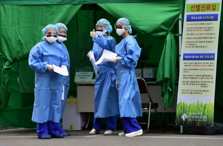 Medical workers in protective gear gather at a separated clinic center for MERS patients, at Konkuk University Hospital in Seoul, in June 2015