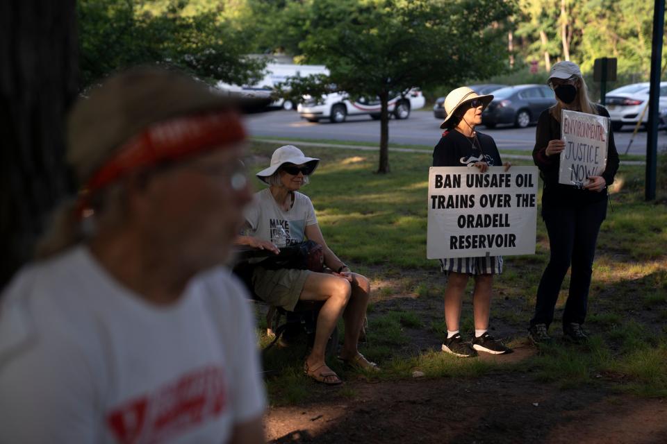 (Right) Holly Cox and Rachel Davis during a rally calling for new legislation regulating trains carrying oil and other hazardous materials at Bookstaver Park in Teaneck on Thursday, July 6, 2023. 