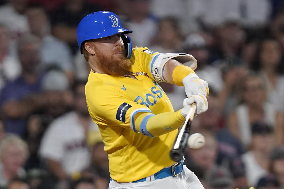 Boston Red Sox's Justin Turner hits a two-run double in the seventh inning of a baseball game against the Atlanta Braves, Wednesday, July 26, 2023, in Boston. (AP Photo/Steven Senne)