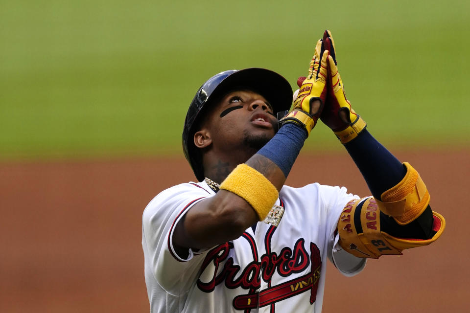 Atlanta Braves' Ronald Acuna Jr. gestures as he scores on his home run in the first inning of the team's baseball game against the New York Mets on Wednesday, June 30, 2021, in Atlanta. (AP Photo/John Bazemore)