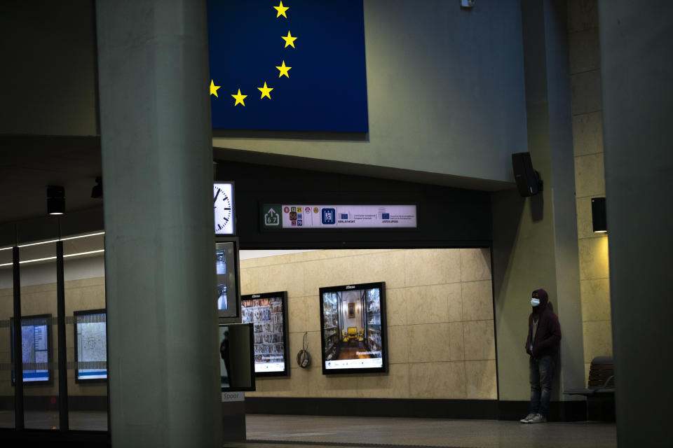 A man wearing a face mask to protect against coronavirus waits for a train at Schuman metro station during a gradual lifting of a lockdown to prevent the spread of the coronavirus, COVID-19, in Brussels, Tuesday, May 5, 2020. Belgium began relaxing some of its lockdown measures on Monday. Business-to-business companies can open their offices to employees again and those taking public transport must wear a mask. (AP Photo/Francisco Seco)