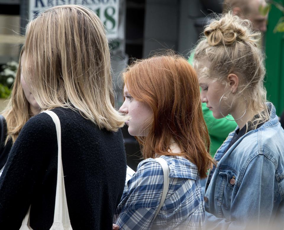 In this Aug. 31, 2018 photo young women listen to a member from one of the Swedish parties in Stockholm, Sweden. (AP Photo/Michael Probst)