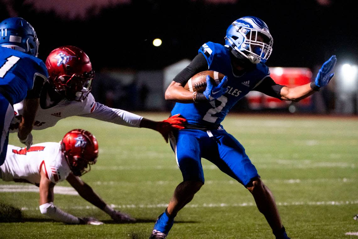 After catching a pass from quarterback Jay O’Neil, Federal Way receiver Dre Jordan evades a tackle attempt on his way up field during the first quarter of a 4A NPSL game against Kennedy Catholic on Friday, Sept. 30, 2022, at Federal Way Memorial Field in Federal Way, Wash.